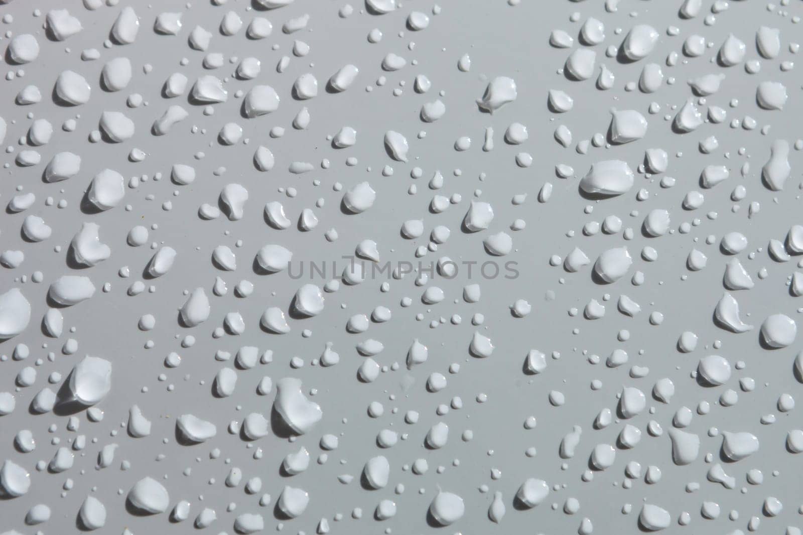 Water drops from rain over a white surface