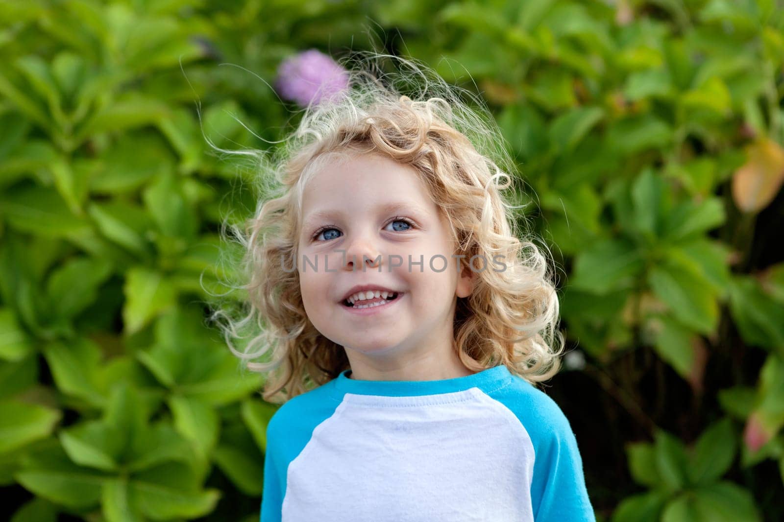 Beautiful boy four year old with long blond hair
