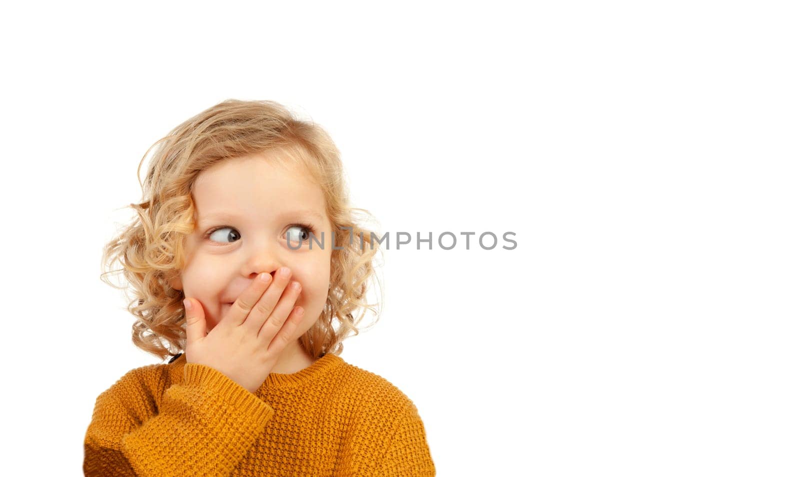 Shy funny child covering his mouth isolated on a white background