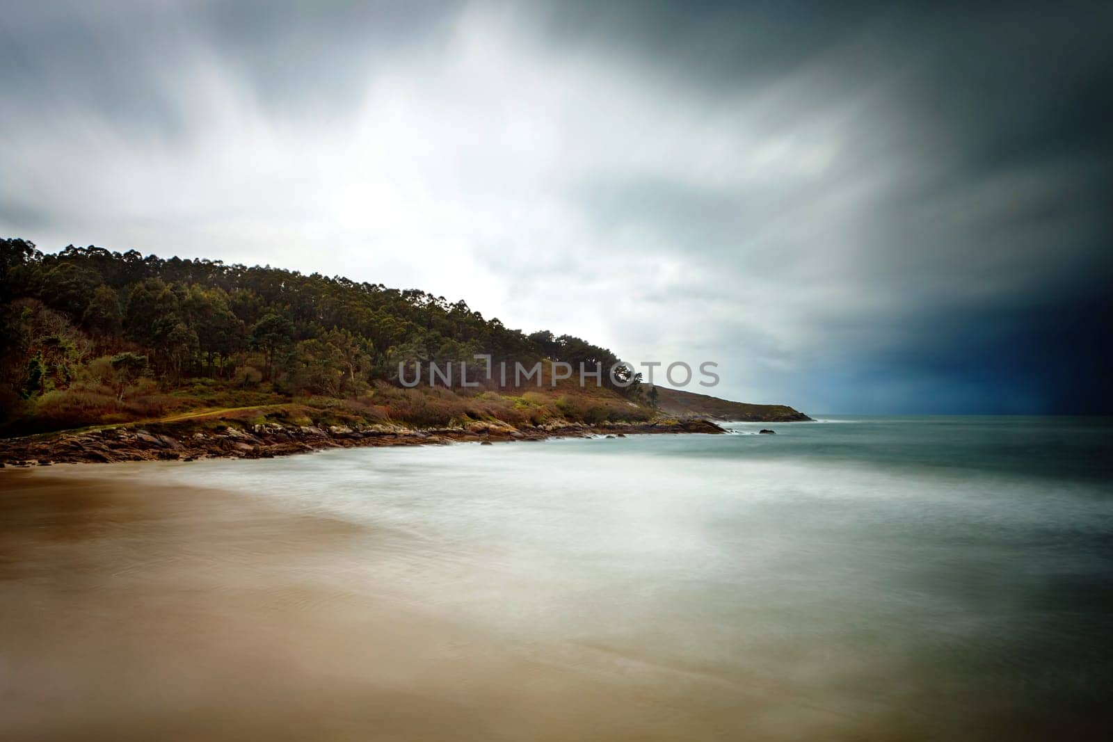 Beautiful seascape on a cloudy day with the sky and the water blurred