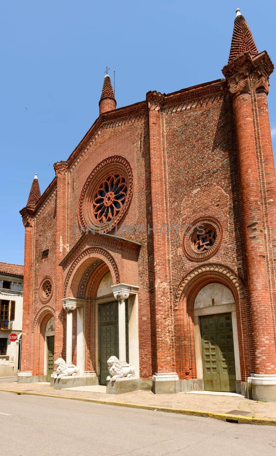 exterior view of main prospect of ancient Romanesque church in Soncino historical center, shot in bright summer light.