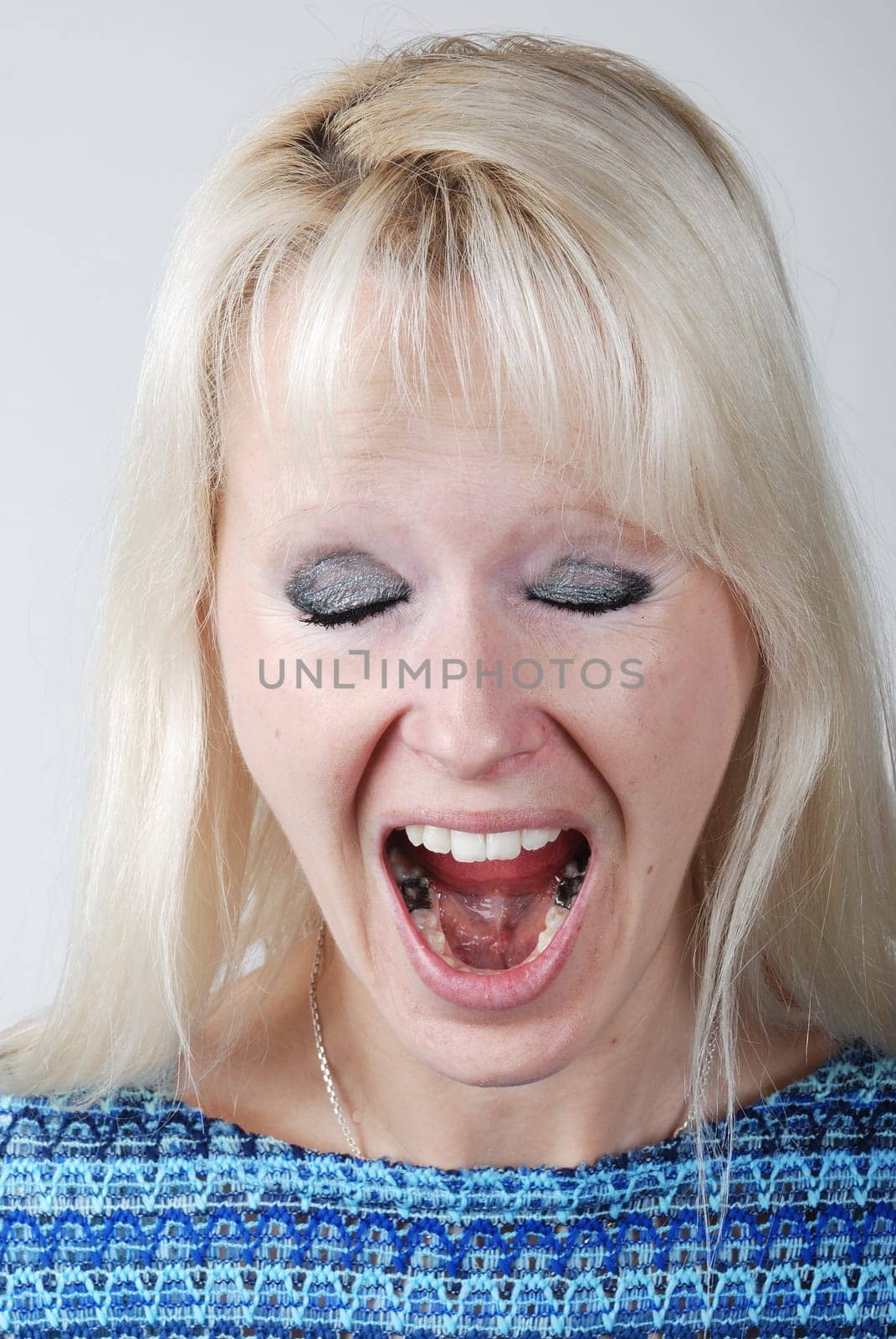 Young blonde woman with a cry