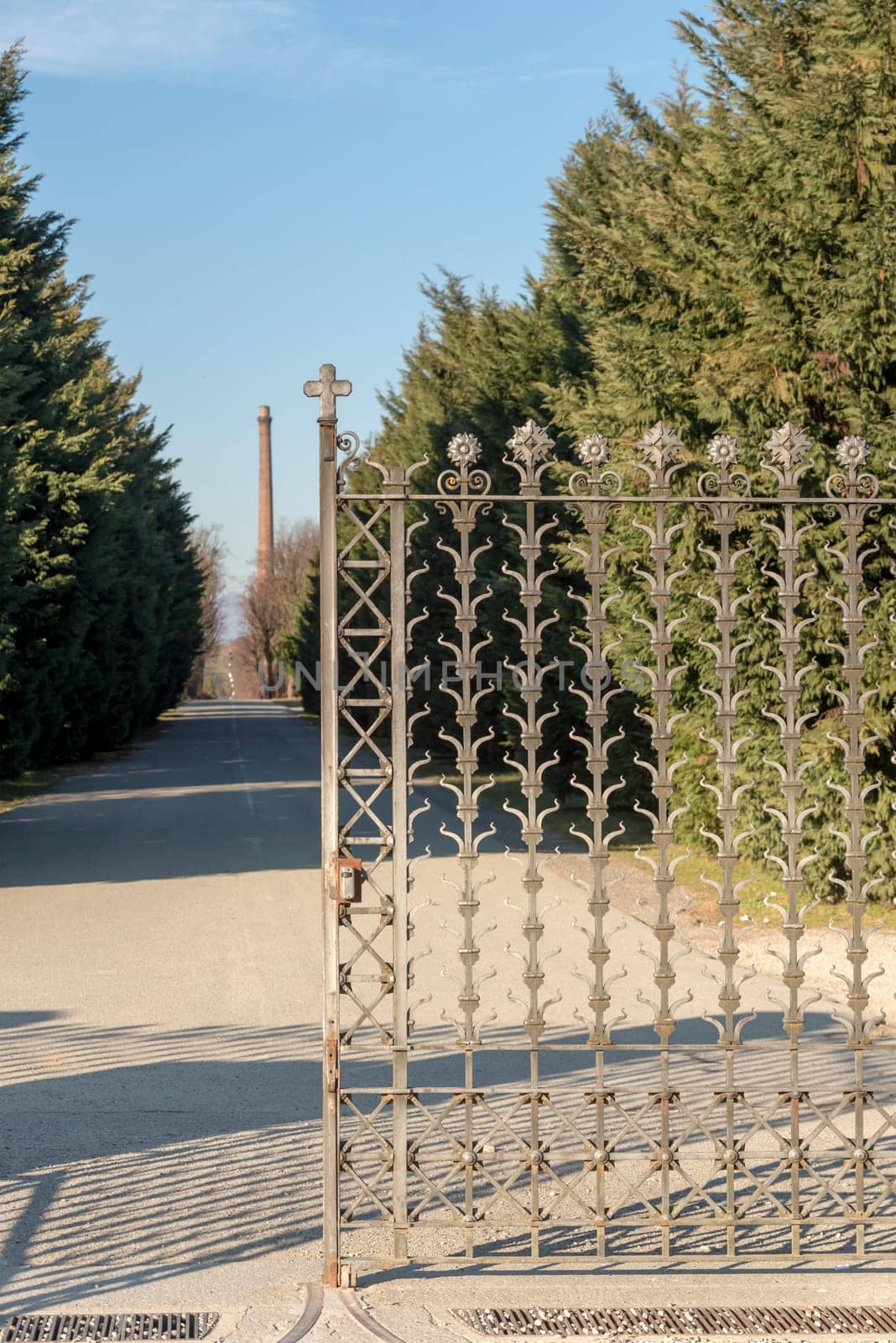 decorated iron gate at historical industrial village, shot in winter at Crespi Adda, Capriate, Lombardy, Italy.