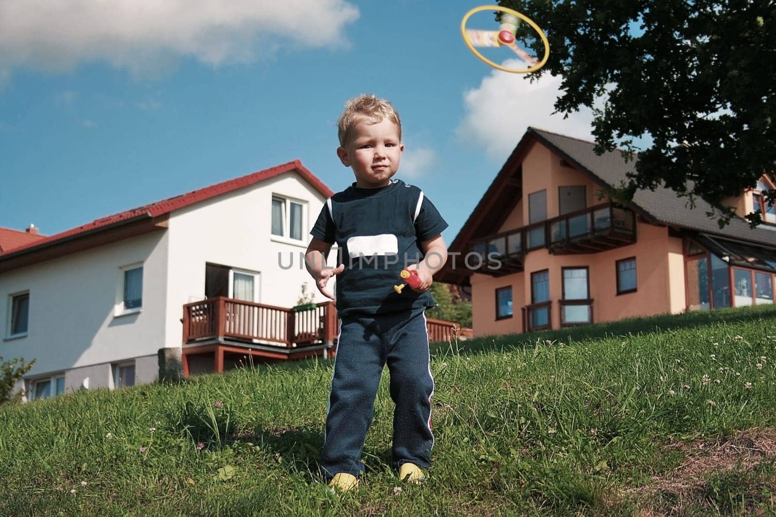 little boy playing with propeller toy