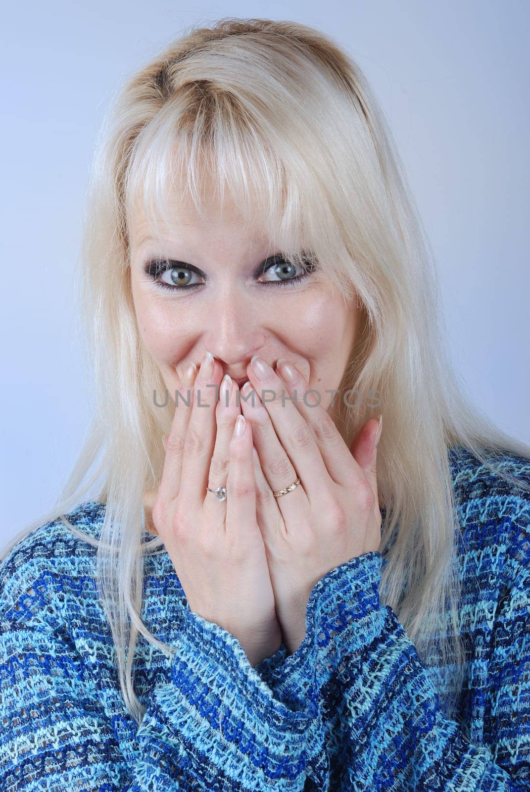 woman hiding her mouth with her hands