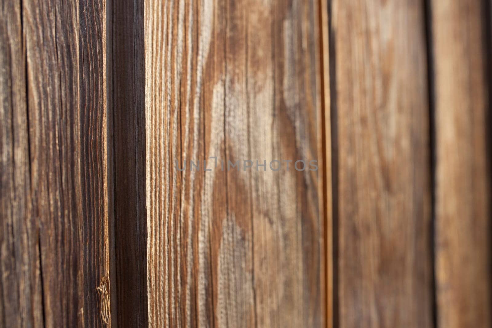 Tongue and groove pine wood wall. Dark knotted and weathered look. Selective focus