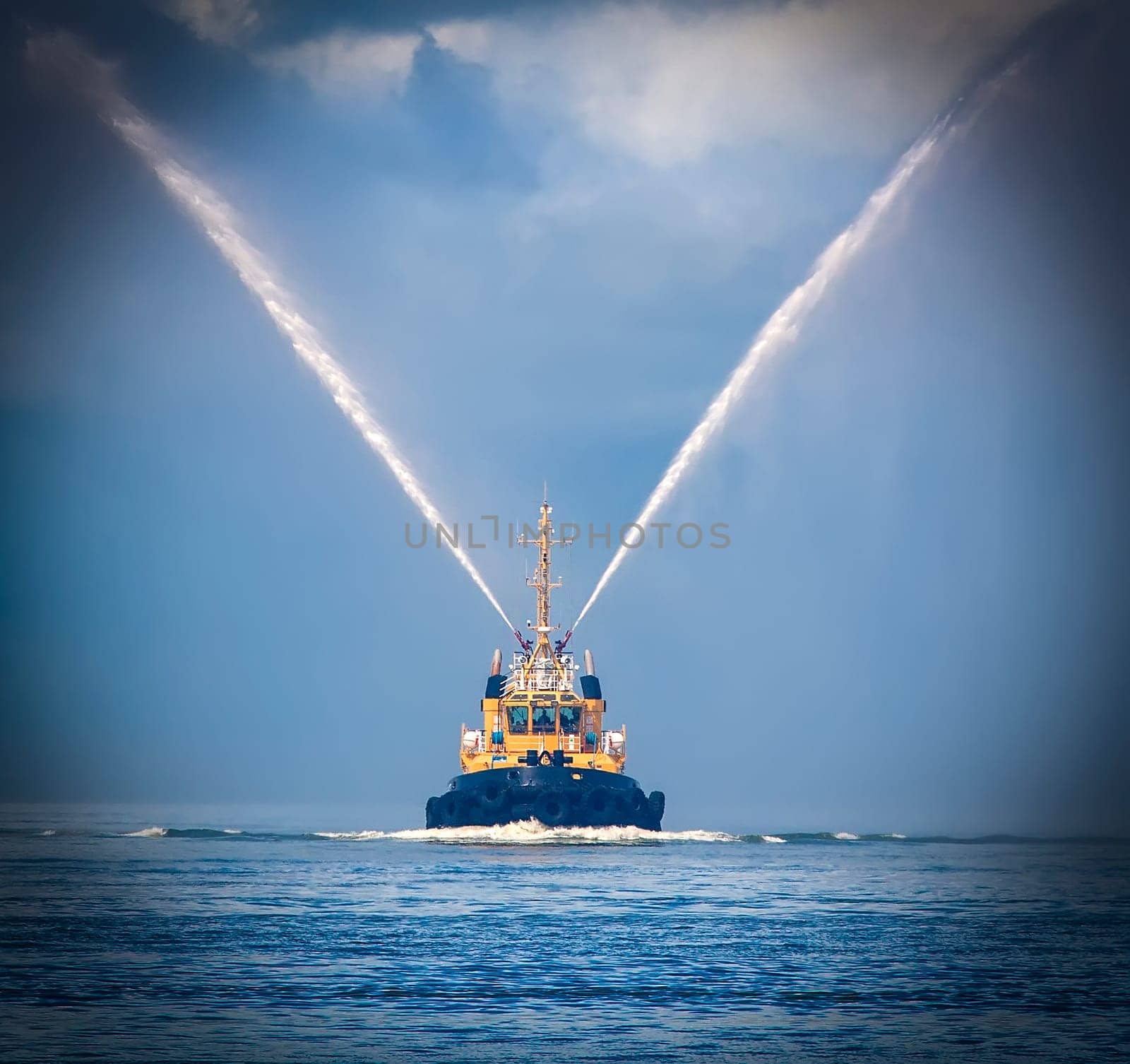 The fire hose boat spraying water on Kamchatka on Paciic ocean