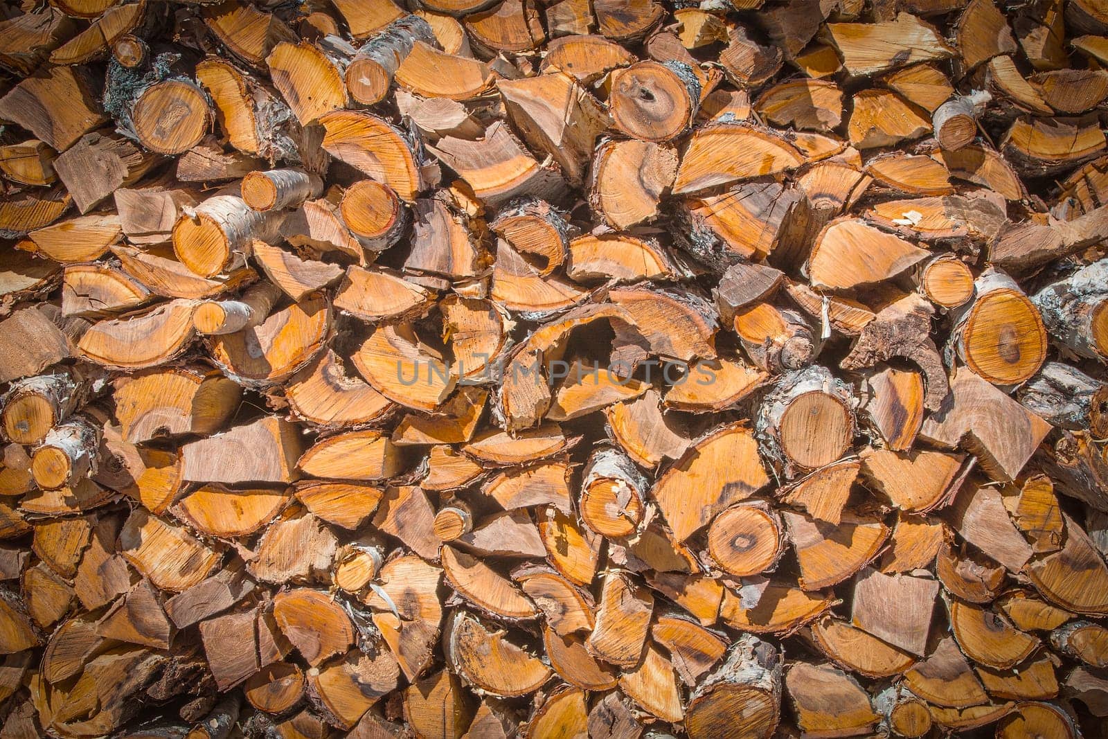The Chopped and stacked pile of pine and birch wood. Texture, background