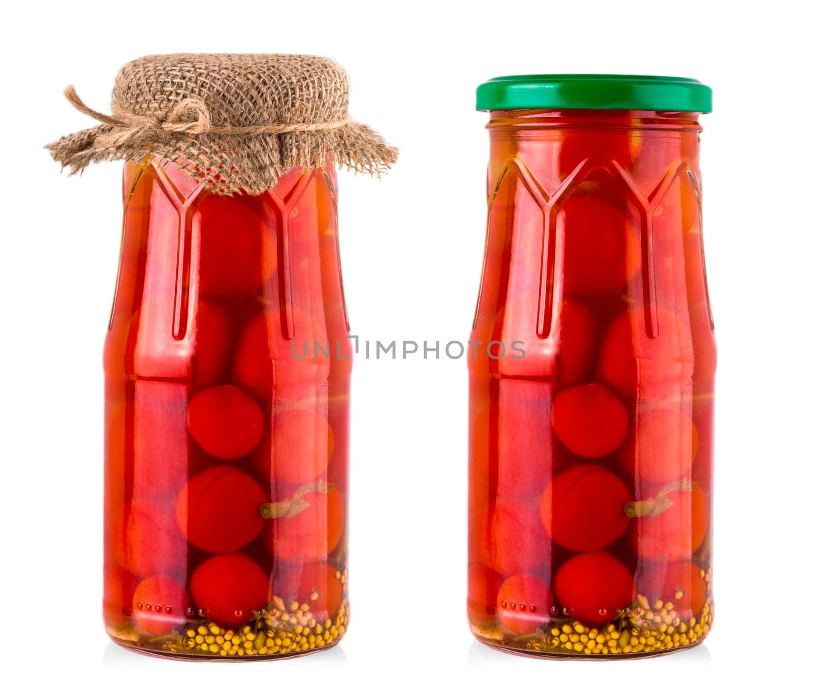 The pickled cherry tomato in glass jar on white background