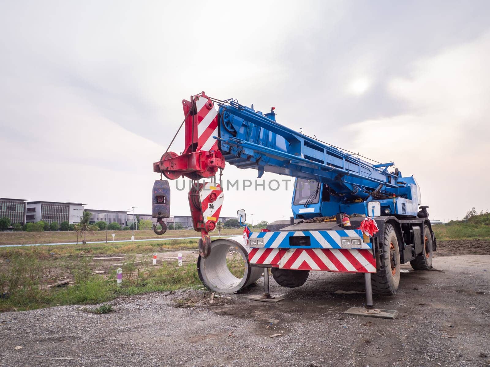 Construction site crane is lifting a led signboard Blank billboard on blue sky background for new advertisement