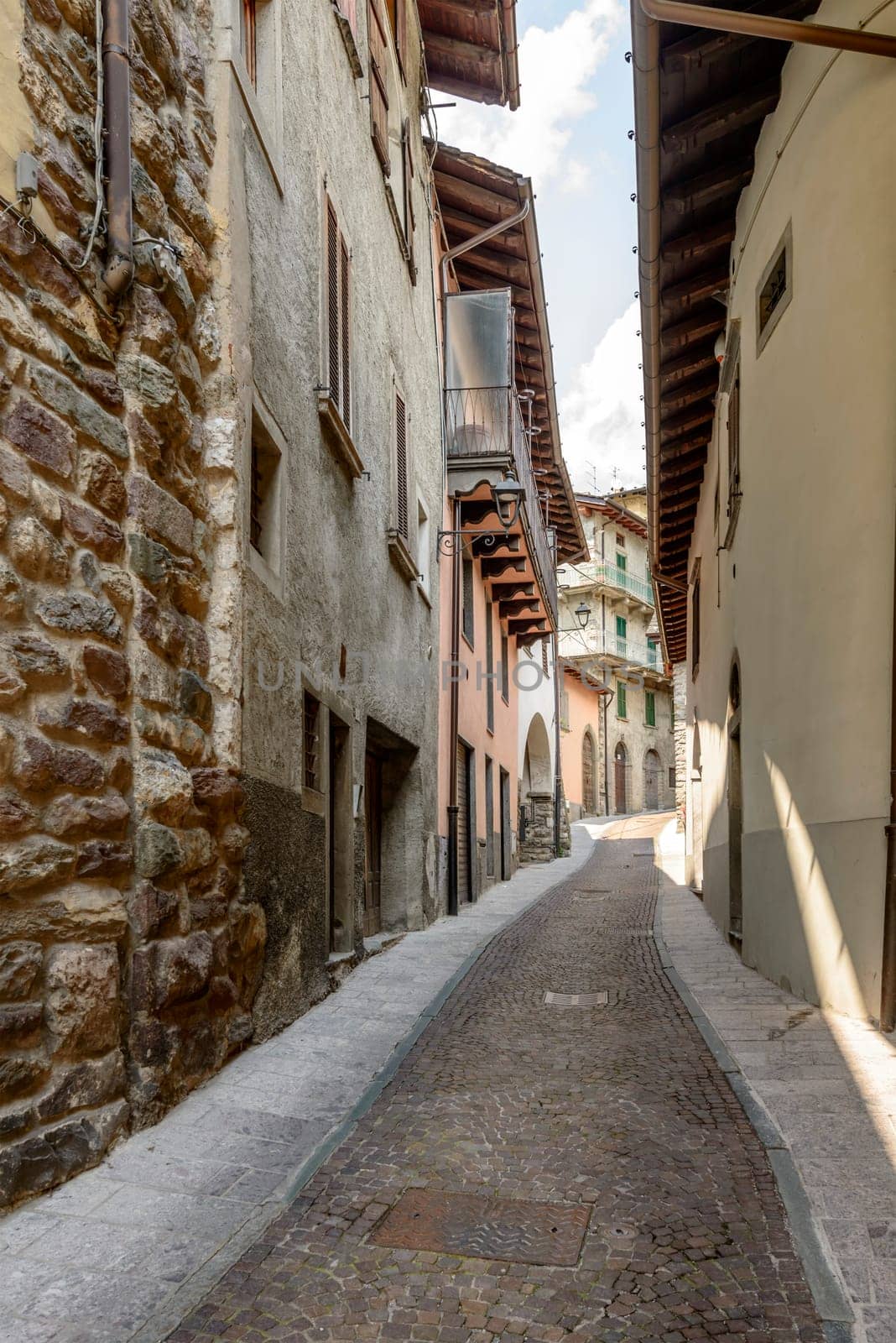 cityscape of historical village  with narrow cobbled street, shot in bright summer light at Gromo, Bergamo, Lombardy, Italy.