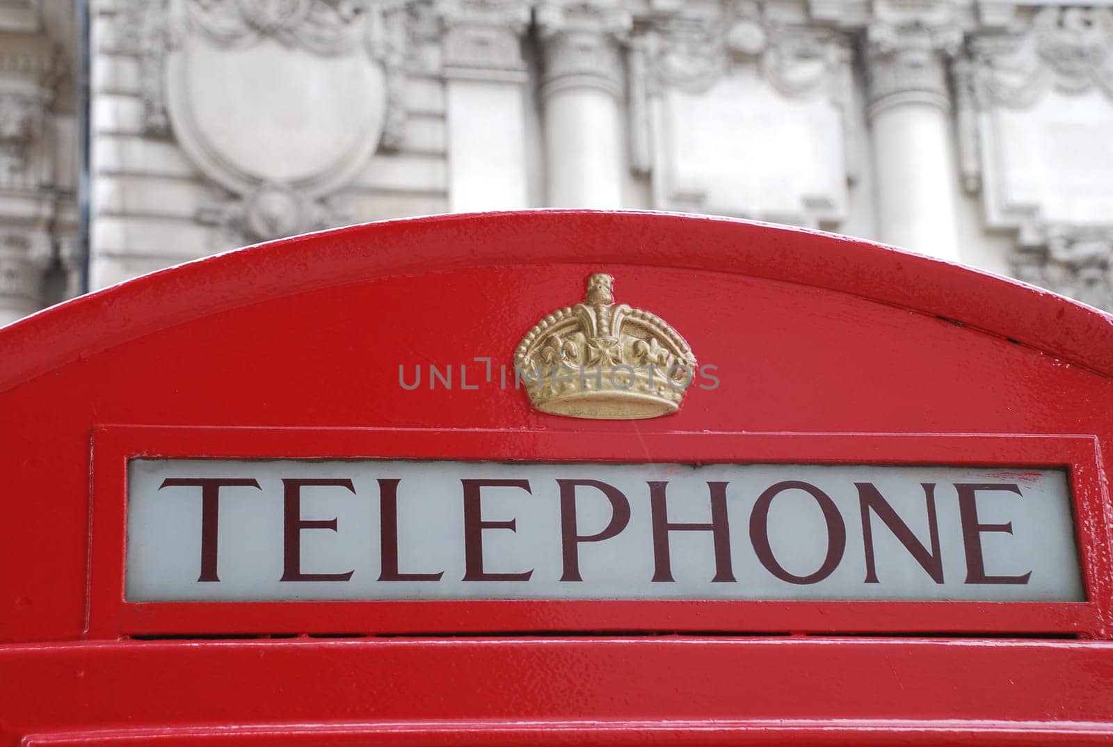 A historic old red telephone box in English London.