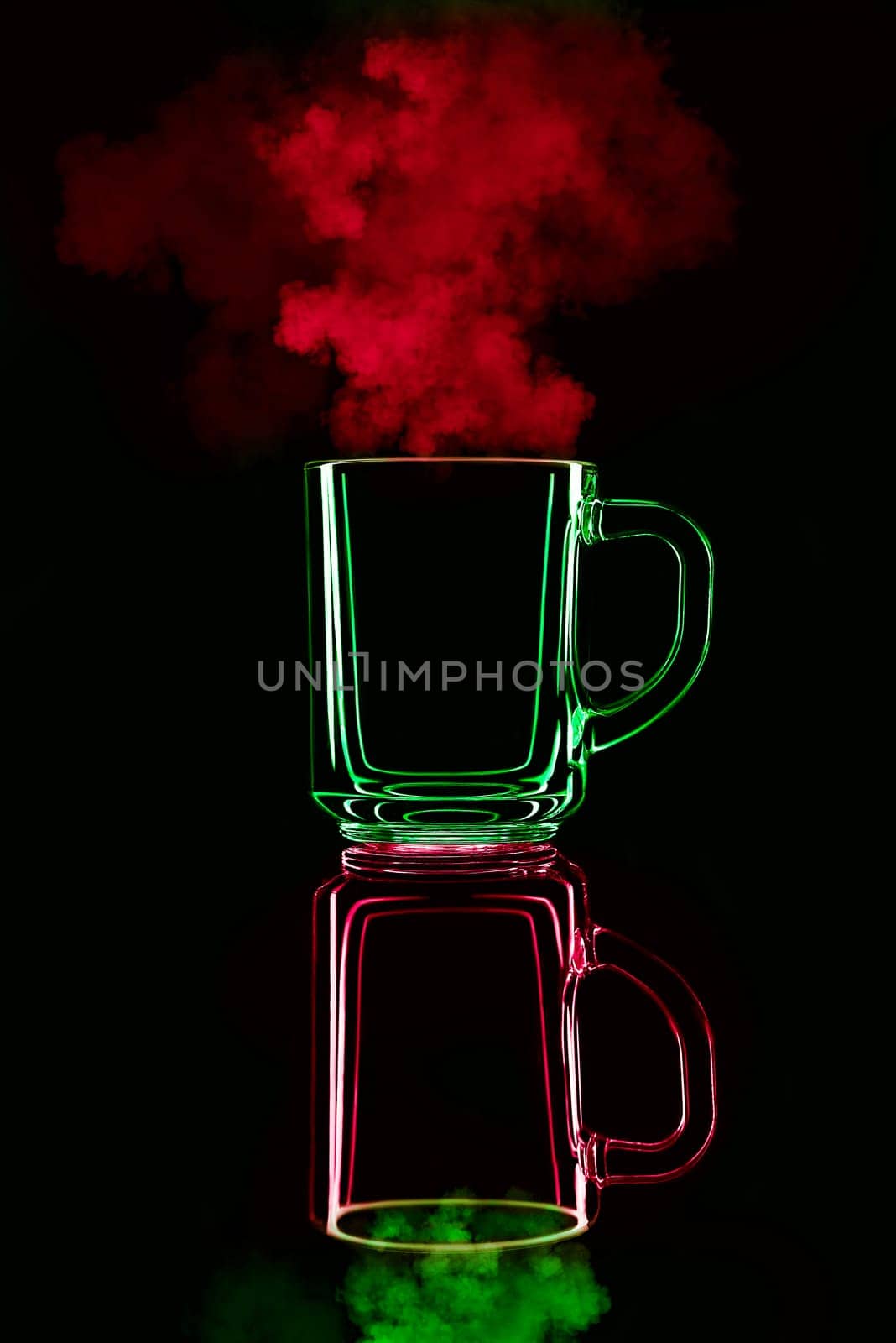 Just a glass on a black background with a reflection. Red and green, with steam. Isolated.