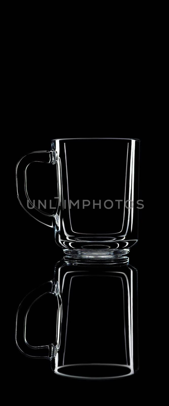 Just a glass on a black background with a reflection. Isolated.