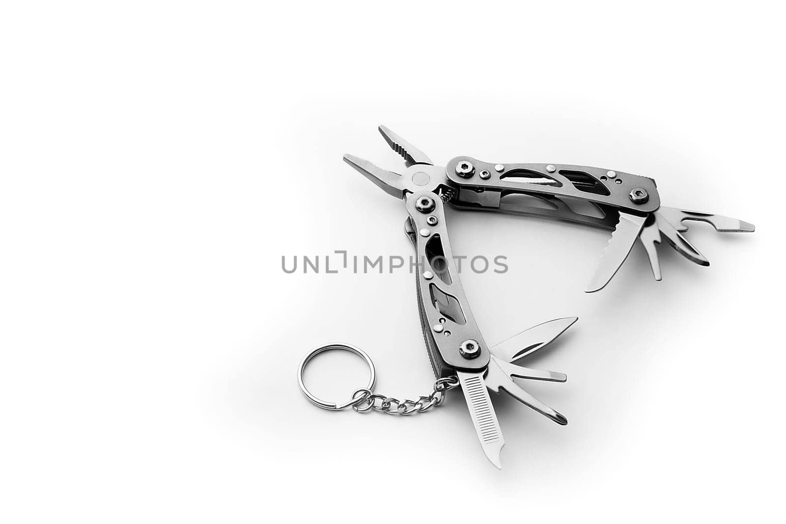 Multi tool with expanded tools and pliers isolated on a white background. Free space for the label or logo, layout, mockup.