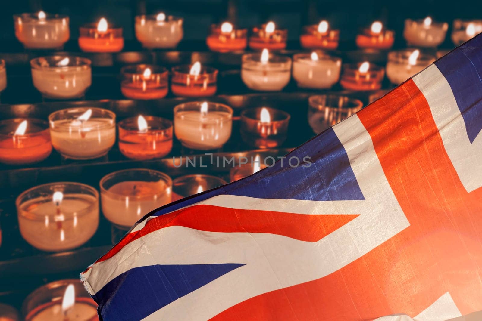 Burning candle and UK flag. The concept of mourning and sorrow in the country, UK national mourning