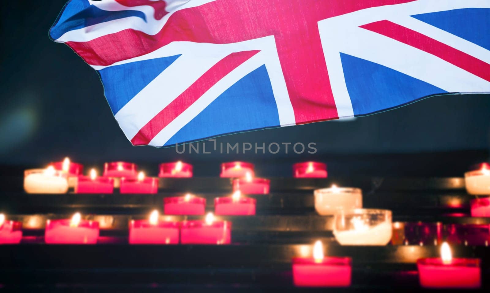 Burning candle and UK flag. The concept of mourning and sorrow in the country, UK national mourning