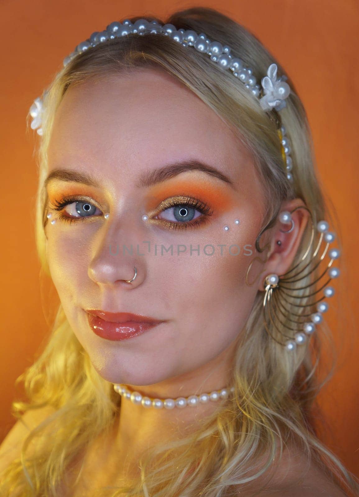 young woman with makeup and pearl jewellery