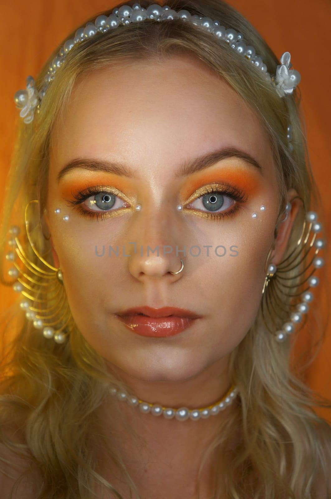 young woman with makeup and pearl jewellery
