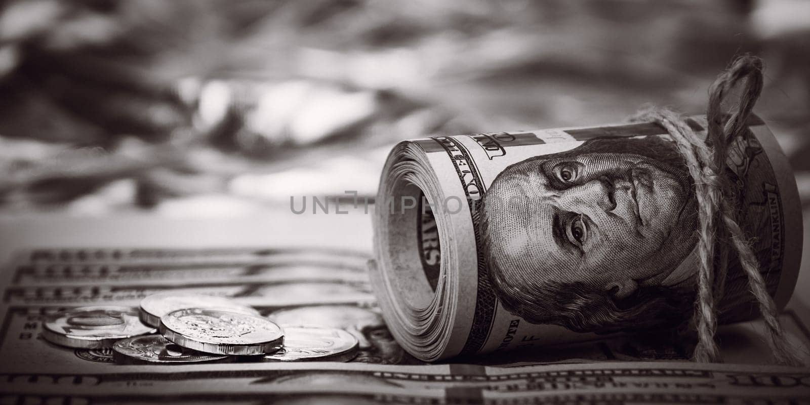 Stacks of coins against the background of hundred-dollar bills are scattered throughout the space. The coins are collected in two columns. The style is black and white.