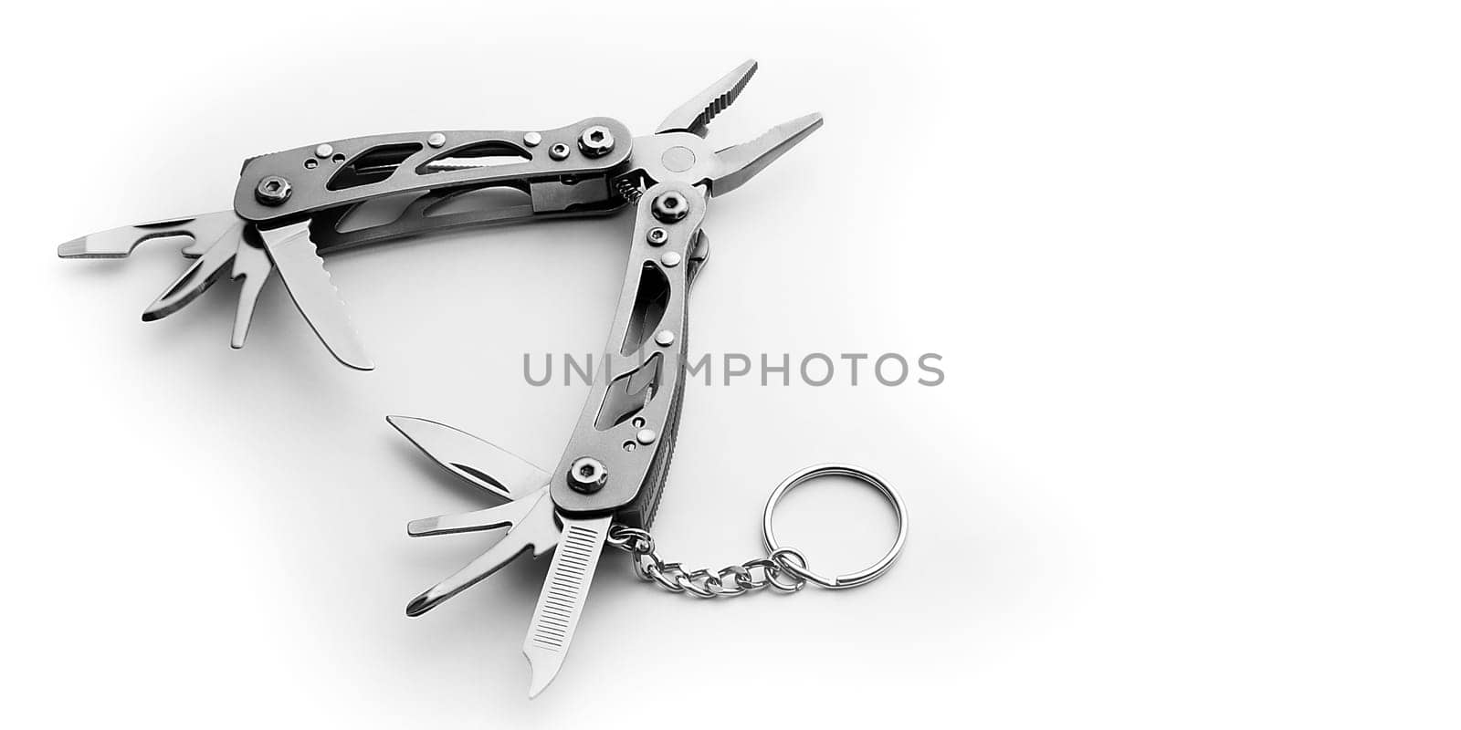 Multi tool with expanded tools and pliers isolated on a white background. Free space for the label or logo, layout, mockup.