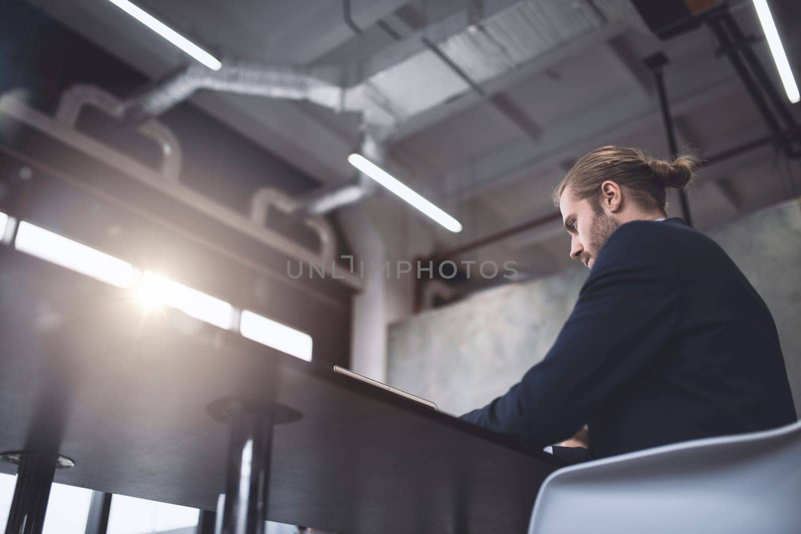 Businessman at the office works with a computer with his team