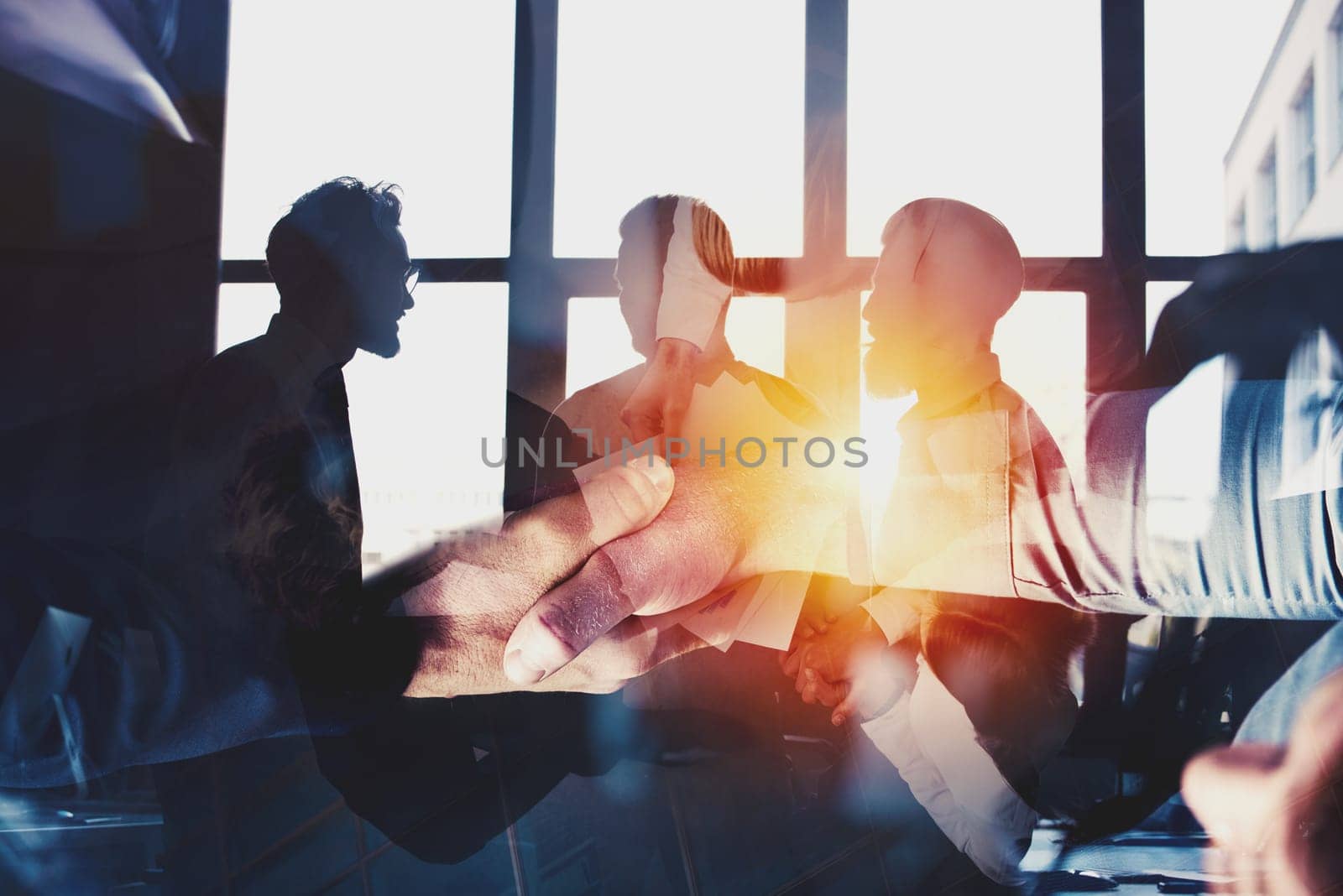 Handshaking business person in the office. concept of teamwork and business partnership. double exposure