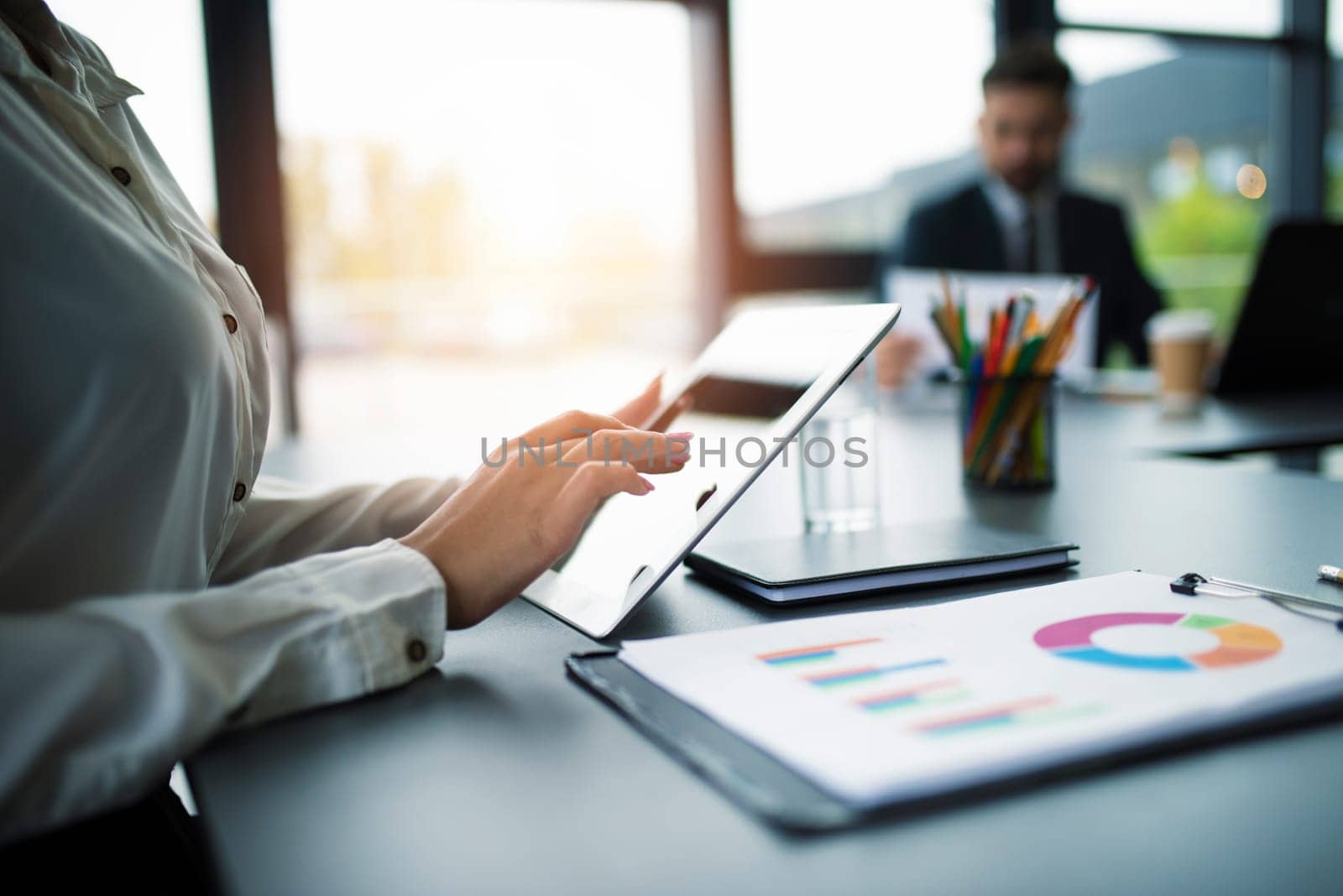 Businesswoman works in office with a tablet. Concept of internet sharing and company startup