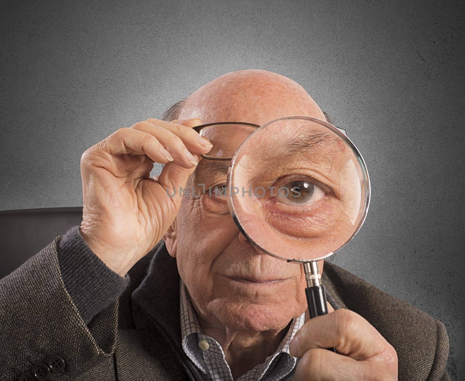 Elder magnifies and tries with magnifying glass