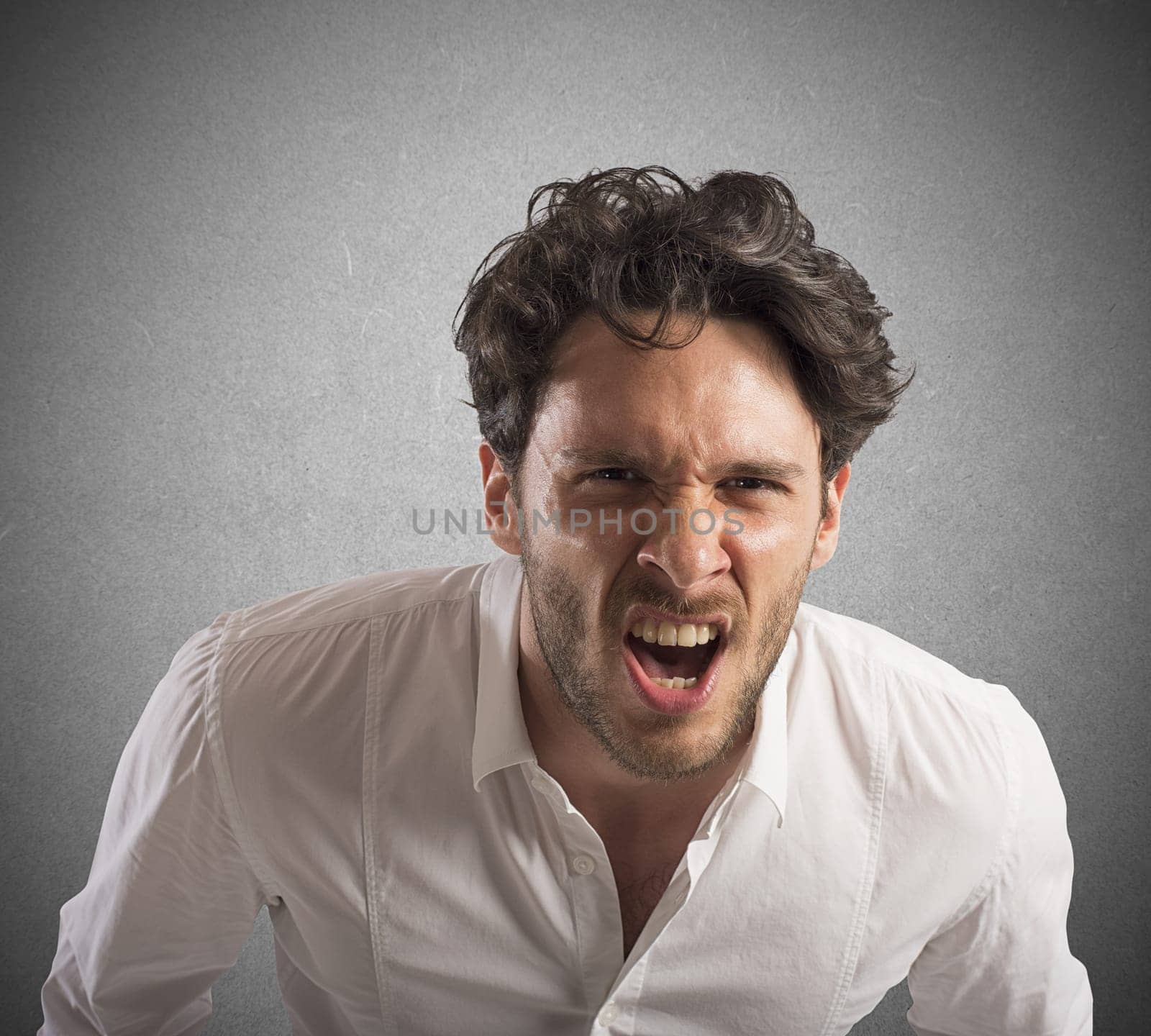 Angry businessman stressed out from work screams