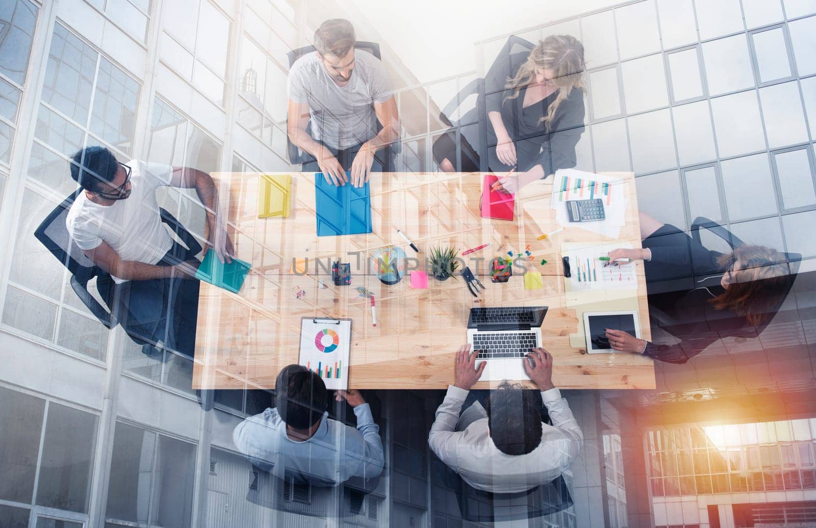Business person work together in a table in office. concept of teamwork, business partnership and startup. double exposure
