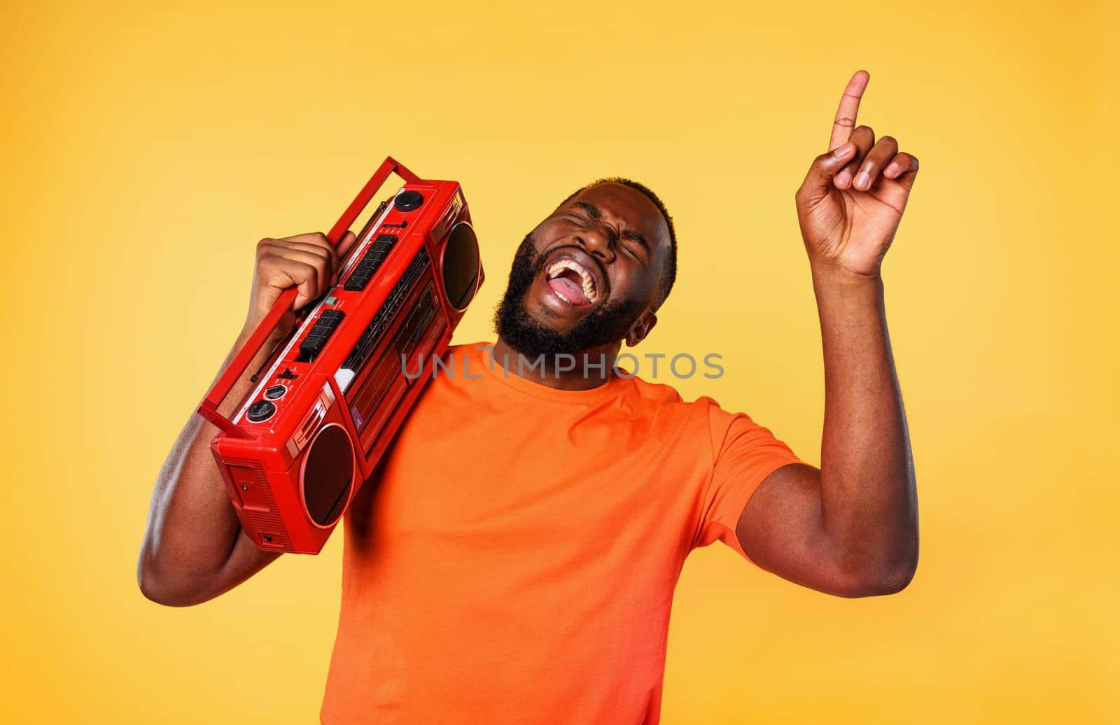 Boy ears the music with an old stereo and dances. emotional and energetic expression
