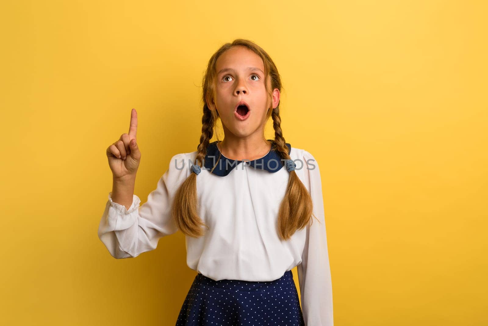 Young student is with shocked expression and indicates something
