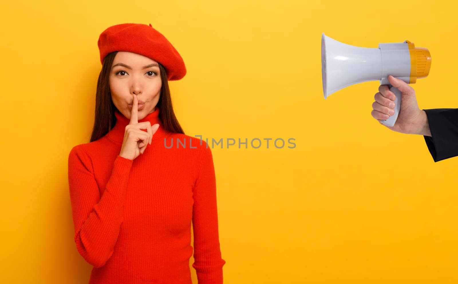 Woman indicates with the hand to be quite.