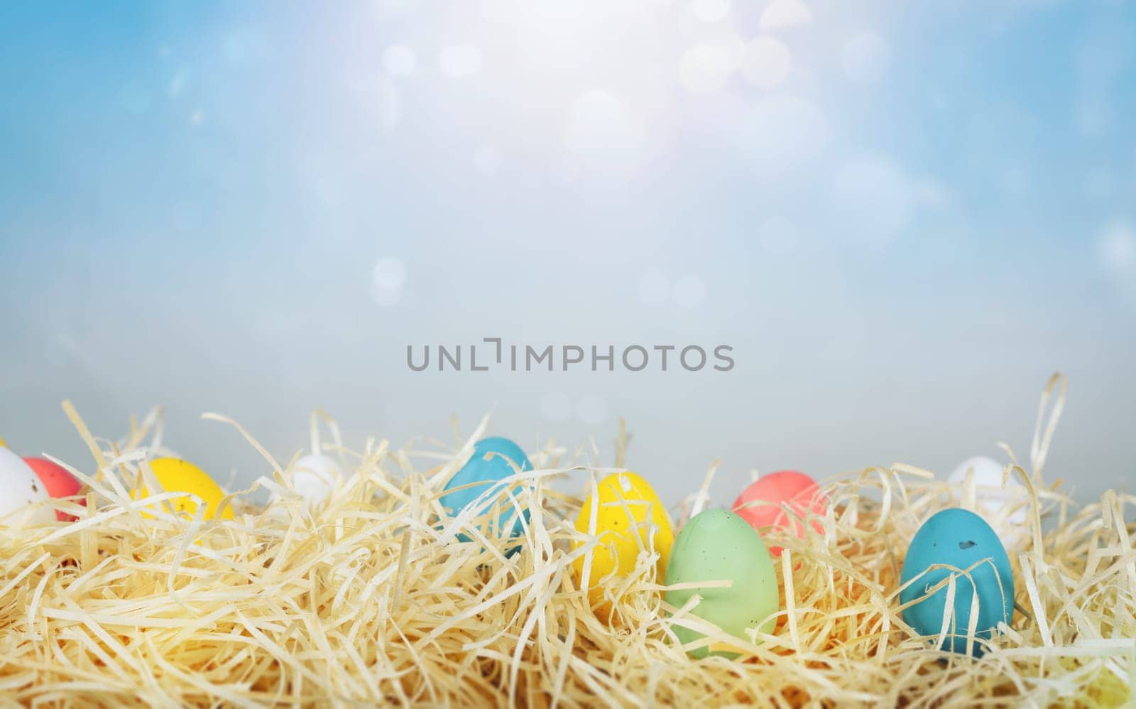 Easter decorations with colored eggs over straw