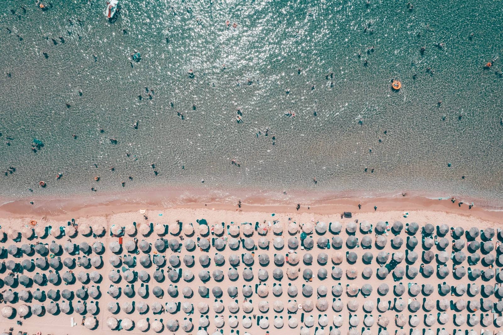 Aerial view of amazing beach with umbrellas and turquoise sea in Greece. Travel concept.