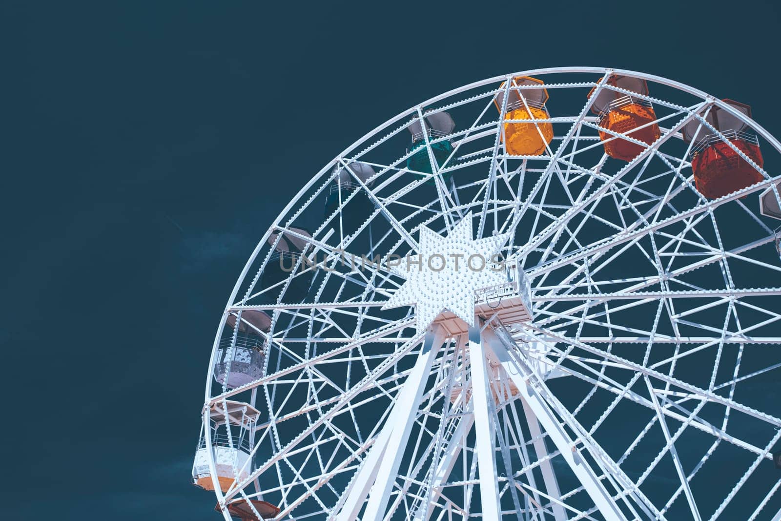 Colorful ferris wheel over blue sky - vintage color