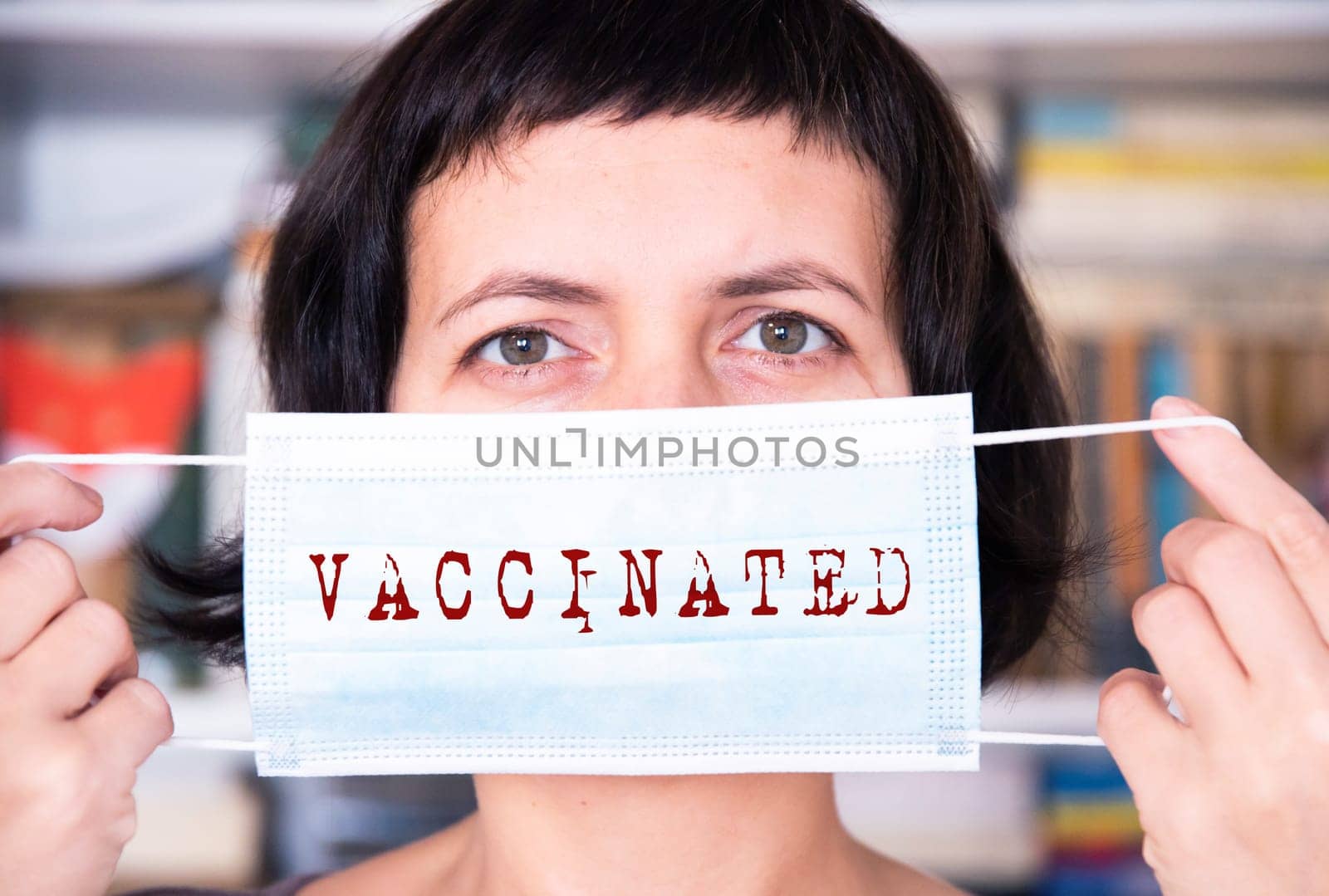 Woman wearing an anti virus protection mask with vaccinated text.