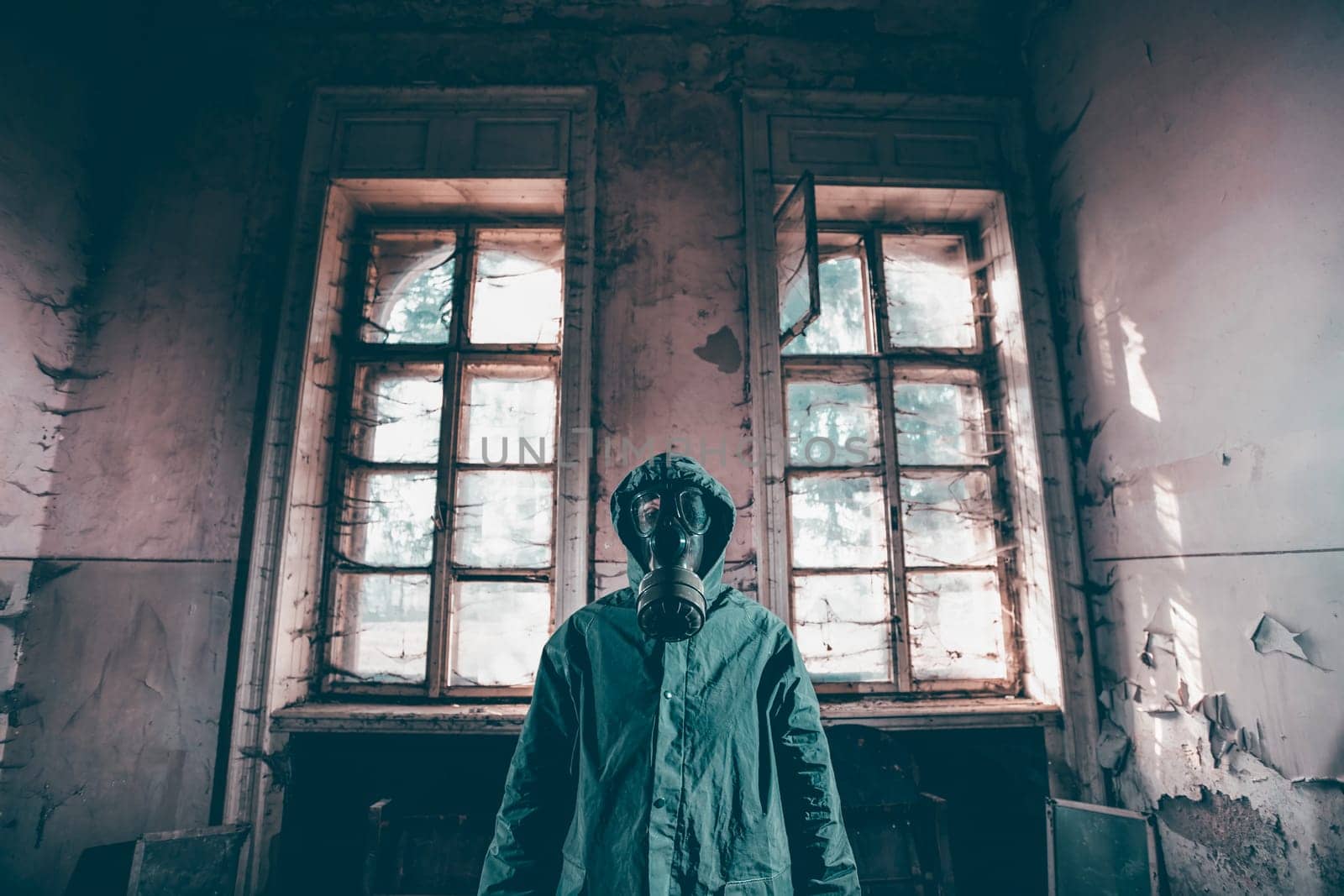 Post apocalyptic survivor in gas mask in a ruined building. Environmental disaster, armageddon concept.