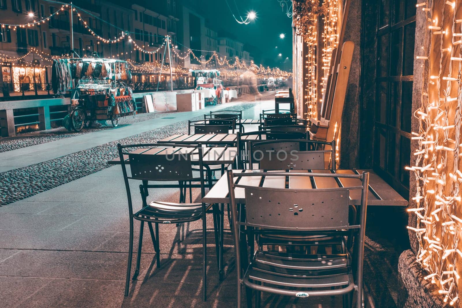 Tables of a milanese outdoor cafe decorated for Christmas.