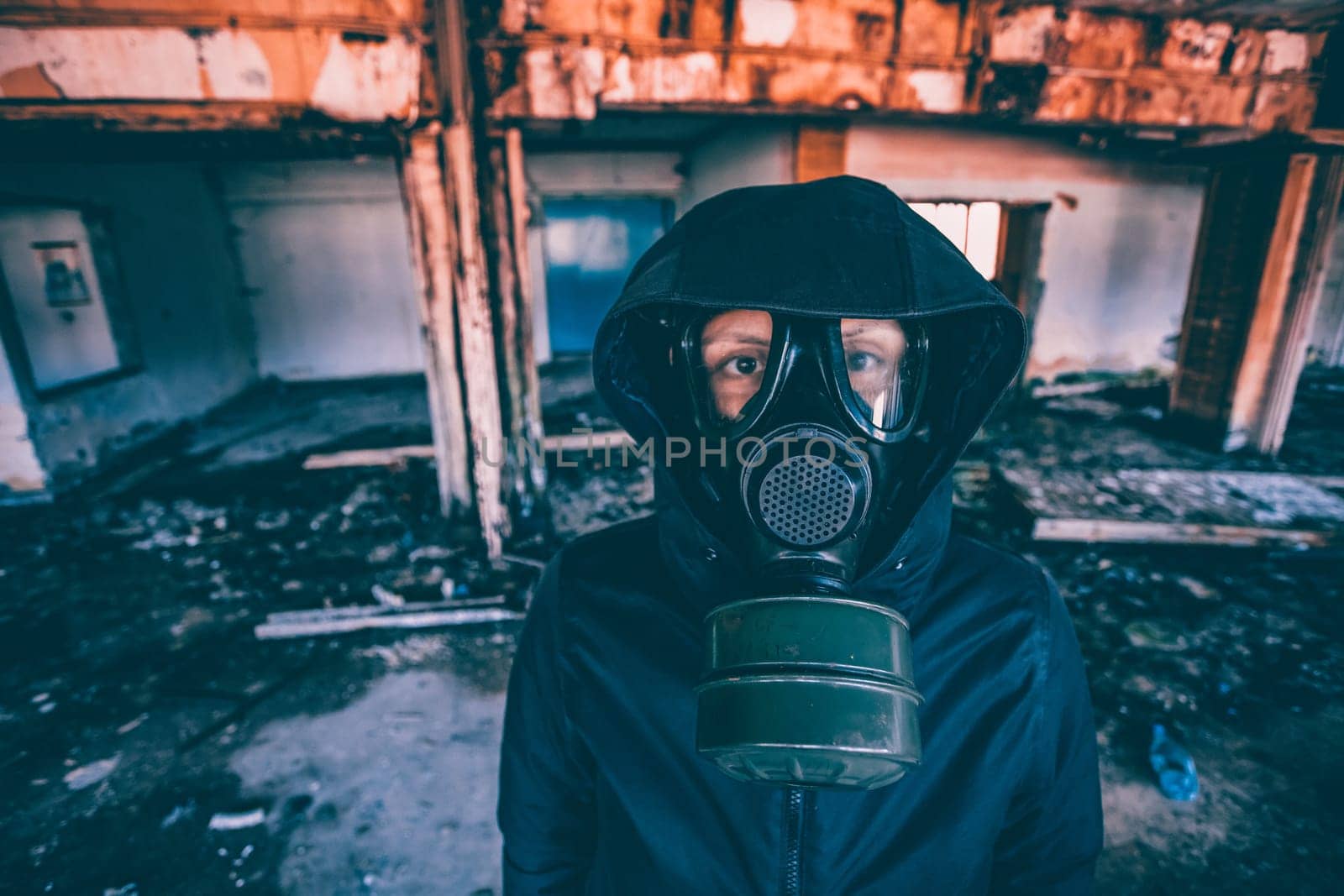 Post apocalyptic survivor in gas mask in a ruined building. Environmental disaster, armageddon concept.