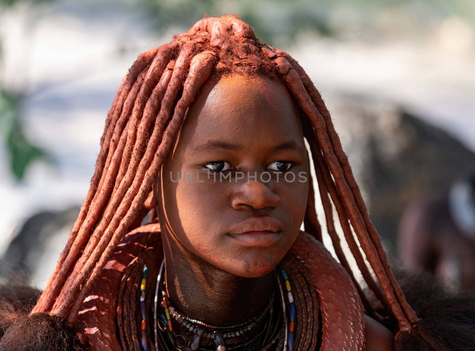 NAMIBIA, OMUSATI REGION, MAY 7: Portrait of Himba woman with traditional hairstyle and red clay painted body. The Himba are indigenous namibian ethnic people, in northern Namibia, May 7, 2018, Namibia