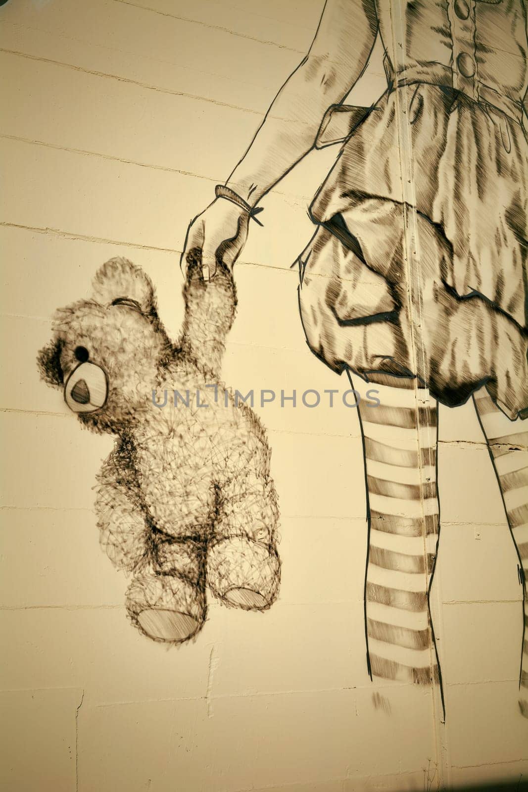 Teddy bear and girl on a facade