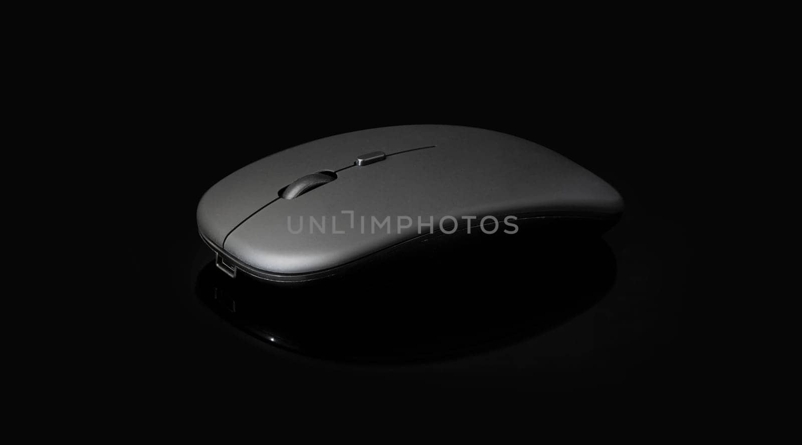 wireless black mouse isolated on black background with clipping path