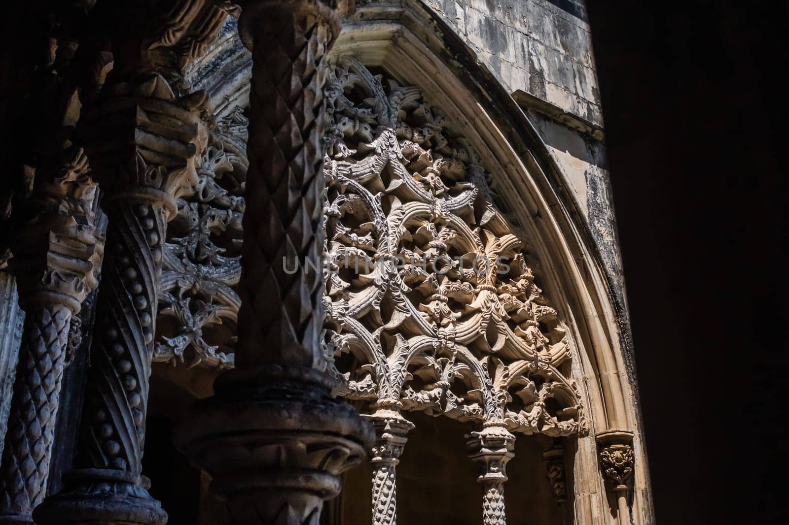 The stunning decorations of the arches in the cloister of the .Batalha Abbey, a Dominican order convent located in the district of Leiria, in Portugal. Close-up architectural detail.