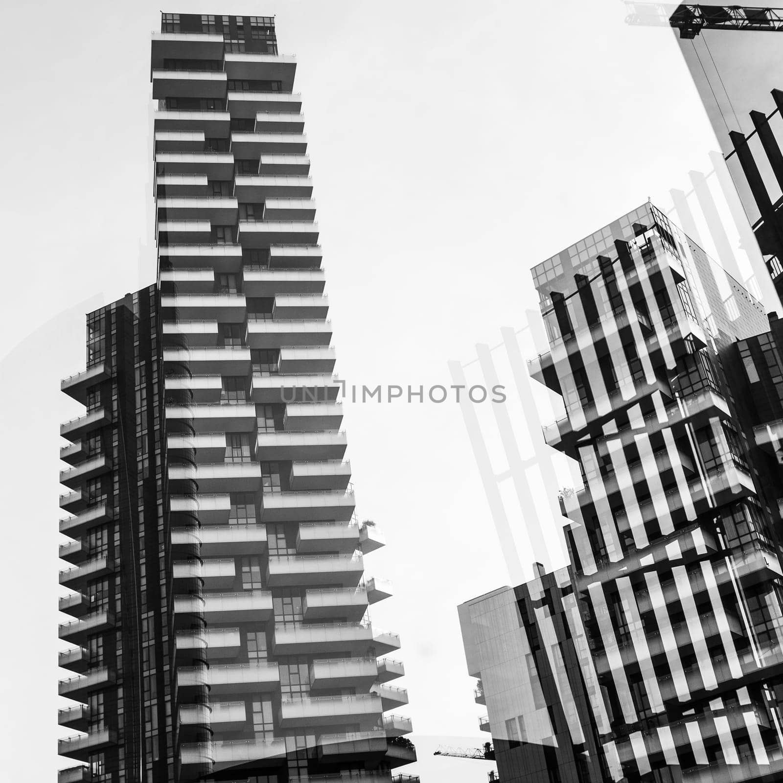 Abstract architectural background showing the Solaria Tower complex, Porta Nuova district in Milan, Italy. Geometric shapes and reflections glass windows overlap in a monochrome background.