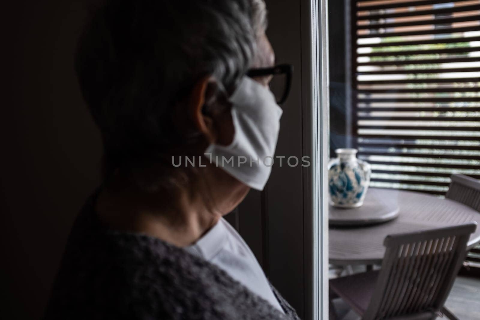 The coronavirus epidemic is a growing concern for older people because they are the population more at risk of mortality. Human face deliberately defocused. Concept of worry and isolation.