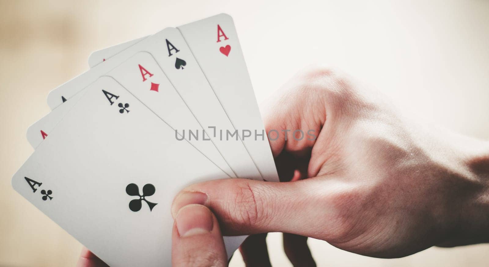 Young man is playing cards, cutout of his hands