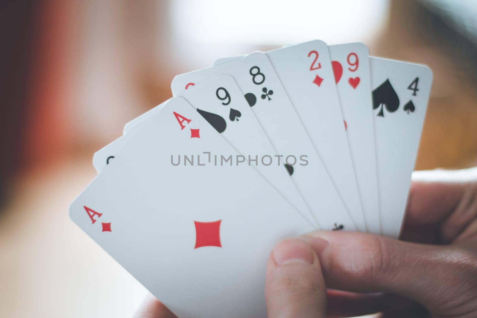 Young man is playing cards, cutout of his hands