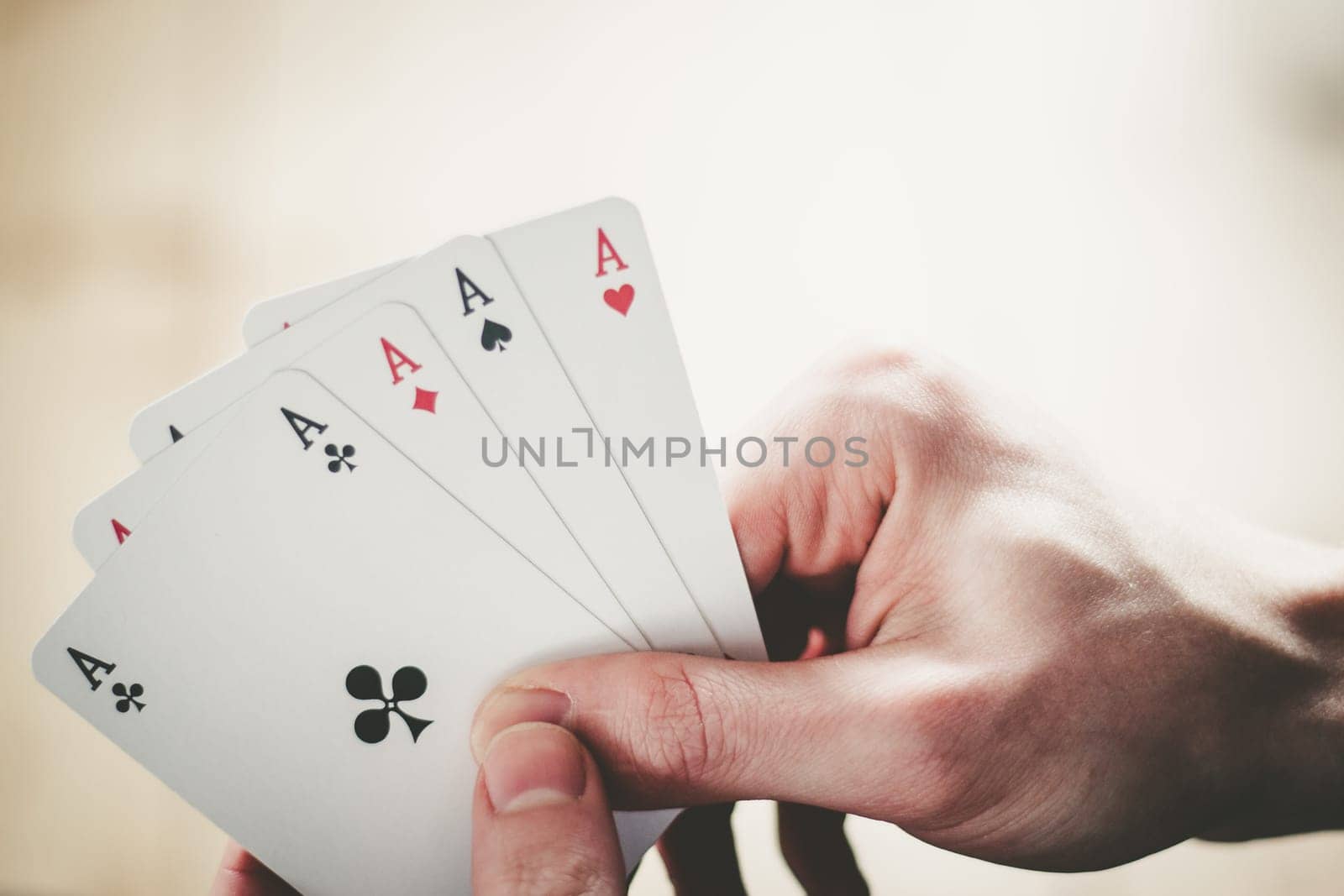 Young man is playing cards, cutout of his hands